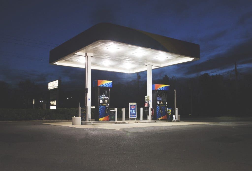 Gas station at night with lights on over the gas pumps