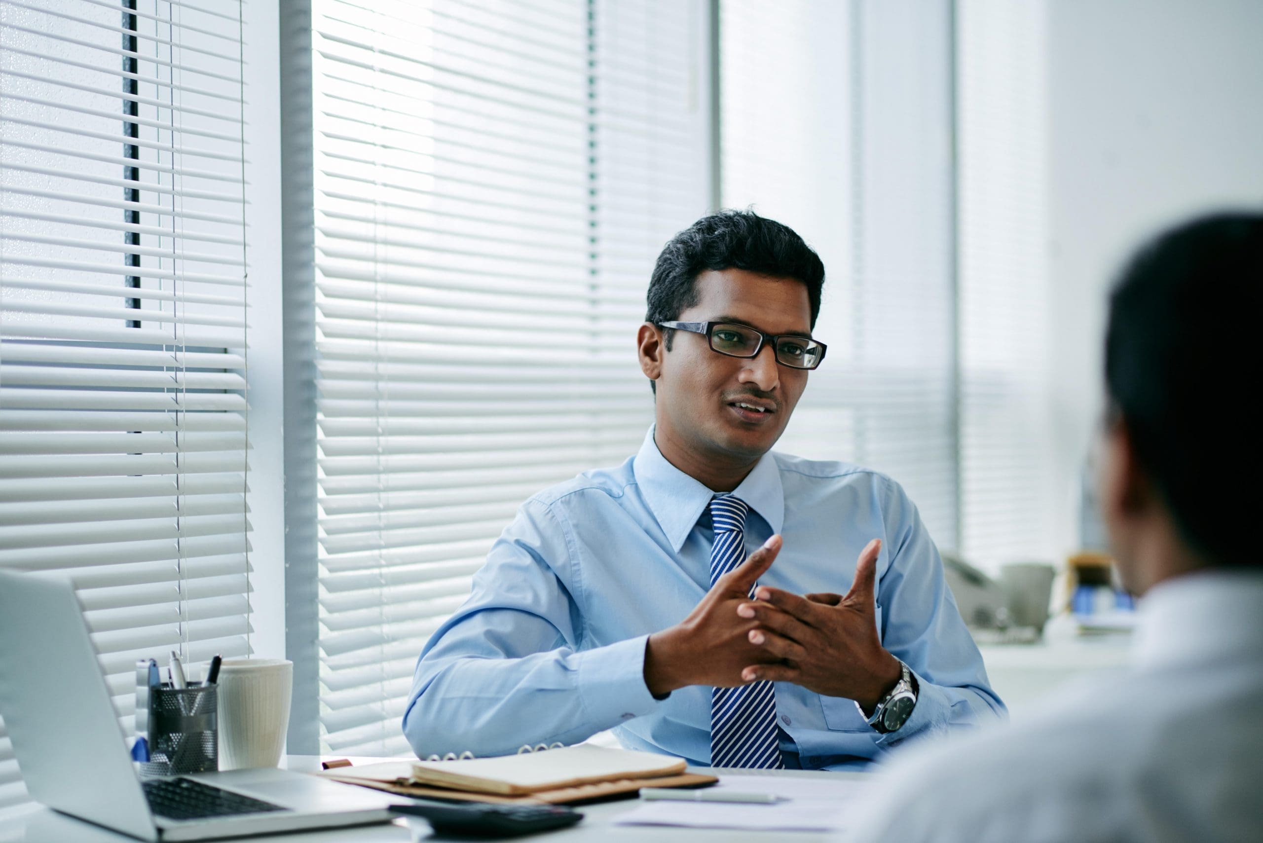 Young businessman talking to his colleague