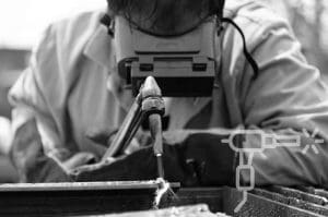 A Tidewater Tech Combination Maritime Welding student welding a metal corner.