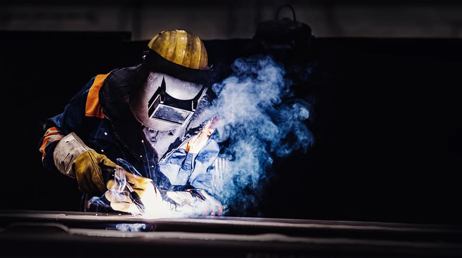 Professional welder working in a factory.
