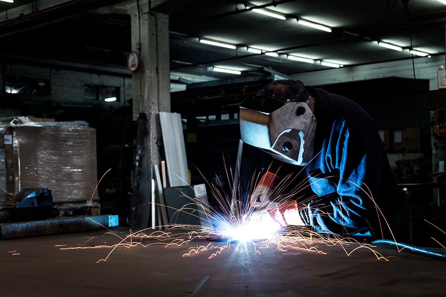 Professional welder working in a machine shop.