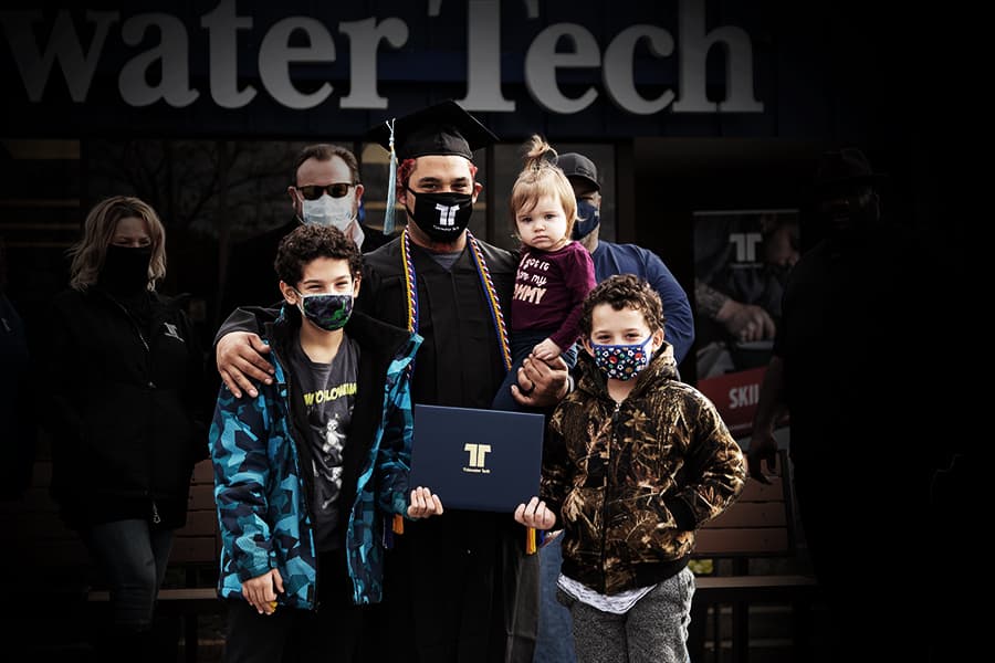 A Tidewater Tech graduate at his commencement ceremony, celebrating with his family.