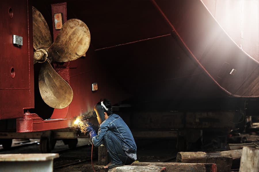 Maritime welder working in a shipyard.